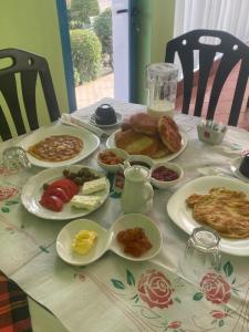 a table with plates of breakfast food on it at Hotel Dini in Vlorë