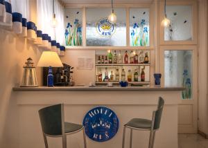 um bar com duas cadeiras e um balcão com bebidas em Hotel Rex em Viareggio