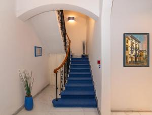 a staircase in a building with blue stairs at Hotel Rex in Viareggio