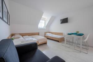 a living room with a couch and a table at Pokoje "Przy Porcie" nad morzem in Darłowo