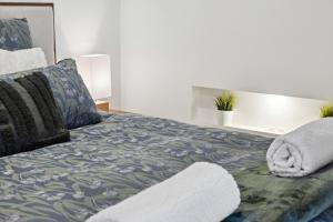 a bedroom with a large bed with pillows at Hill Moi Country stay by the Sea in Victor Harbor