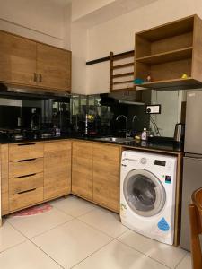 a kitchen with a washing machine in the floor at Homestay Timurbay in Kuantan
