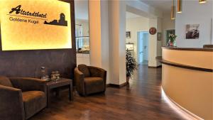 a lobby of a coffee shop with chairs and a counter at Altstadthotel Goldene Kugel in Waren