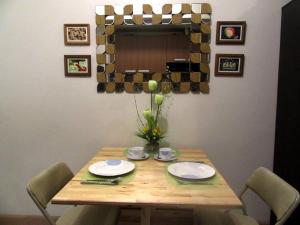 a wooden table with chairs and plates on it at A cozy, relaxing condo at city center in Davao City