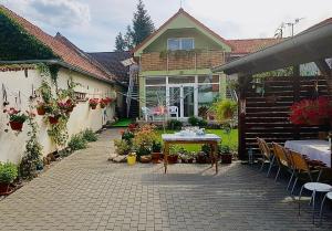 a patio with a table in front of a house at Apartmány Pálava Novosedly in Novosedly