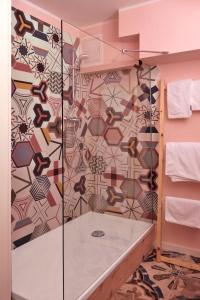 un bagno con doccia e parete a mosaico di Gästezimmer Klassen(T)raum a Rheurdt