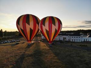 two hot air balloons in a field at sunset at Villa Bellagio Amboise by Popinns in Amboise