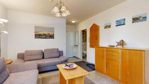 a living room with a couch and a table at a cappella 01 im Binz, strandnahe FeWo mit Schwimmbad im Haus, in Binz