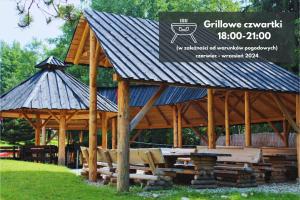 a large wooden pavilion with a sign on it at Kompleks Antałówka Termy & Med in Zakopane