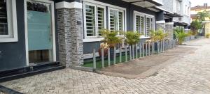 a building with potted plants on the side of it at A's Hospitality in Ikeja