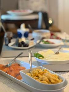 a table with plates of food on a table at Hauane Bed and Breakfast in Sandnes