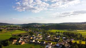 an aerial view of a small village in the hills at Tinyhaushotel - Campingpark Nabburg in Nabburg