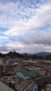 a view of a city with houses and buildings at Arunachal Guest house in Hāpoli
