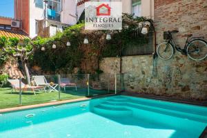 a swimming pool in front of a building at Casa MareMar in Palamós