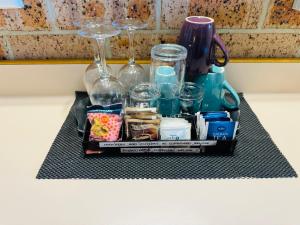 a tray with glasses and other items on a counter at Town and Country Motor Inn in Tamworth