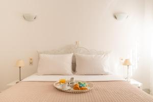 a bed with a tray of food on it at Elio A 1BDR Apt with Garden 1 min from the beach by Hospi in Heraklio Town