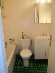 a bathroom with a toilet and a sink and a tub at Isis in La Grande-Motte