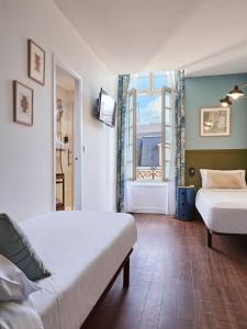 Postel nebo postele na pokoji v ubytování Hôtel Bordeaux Clémenceau by Happyculture
