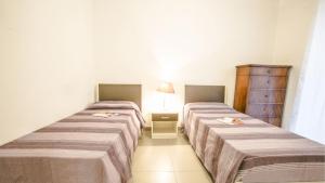 En eller flere senge i et værelse på Myconos Deluxe D3 - Pineto Vacanza