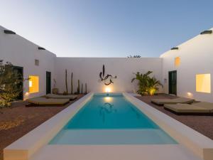 a swimming pool in the backyard of a house at Casa Montelongo - Adults Only in La Oliva