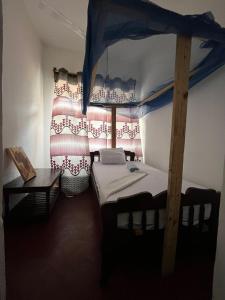 Кровать или кровати в номере Flamingo Guest House ZNZ