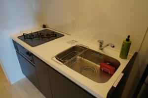 a kitchen counter with a sink and a stove at REVISION Kairouyama-tei - Vacation STAY 15801 in Hiroshima