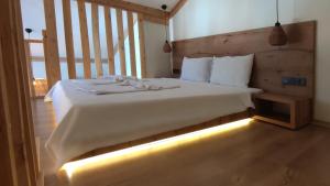 a bedroom with a white bed with lights on it at GUNEŞ BOUTIQUE OTEL in Fethiye