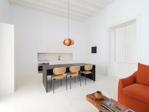 a kitchen with a table and chairs and a couch at Casa Montelongo - Adults Only in La Oliva