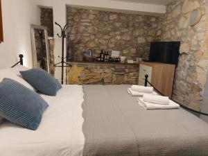a bedroom with a large bed with towels on it at Apartment Balinovaca in Skradin