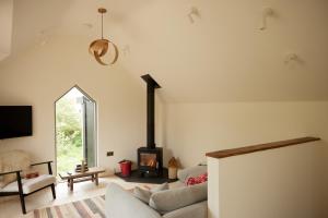a living room with a couch and a fireplace at The Old Winery Cottage No2 in Shepton Mallet