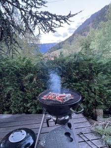a bbq grill on a deck with a view at Chalet Yuki in Morzine