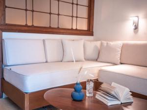 a living room with a couch and a coffee table at Dracos Hotel in Parga