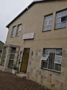 a building with a sign on the side of it at Mabhida Guesthouse in Durban