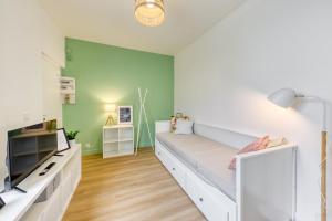 a bedroom with a bed and a green wall at Le Nid Cozy - Face Gare De Corbeil in Corbeil-Essonnes