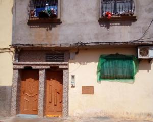a building with two doors and two windows at Amina Apartment in Ikhorbane