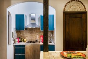 a kitchen with blue cabinets and a plate on the counter at Cozy Little House in Camogli by Wonderful Italy in Camogli +7 photos