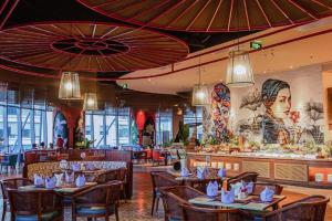 a restaurant with tables and chairs and a bar at HD Panorama Nha Trang Condotel- 2 nguyen thi minh khai, nha trang in Nha Trang