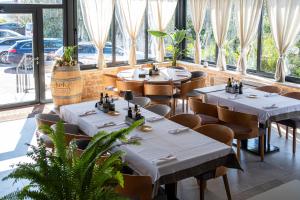 a restaurant with tables and chairs and windows at Villa Anton in Sukošan +29 photos