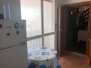 a kitchen with a table next to a refrigerator at Villa sul mare in Bisceglie