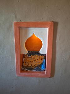 a picture of a framed picture of a building at Riad Merzouga Dunes in Merzouga