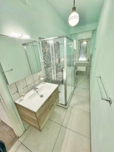a bathroom with a sink and a shower at Appartamento Elena in Cefalù +34 photos