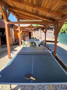 a ping pong table under a wooden pergola at Ubytovani U Švýcarů in Turnov