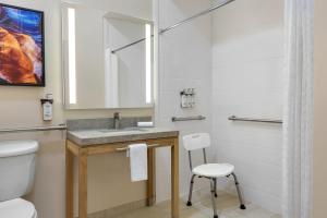 a bathroom with a sink and a toilet and a mirror at Candlewood Suites Vicksburg by IHG in Vicksburg