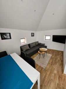 a living room with a couch and a table at Magazaki Apartments Tešnjar in Valjevo