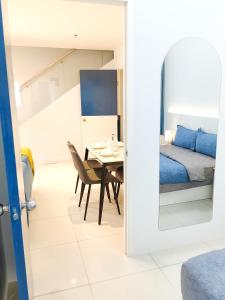 a bedroom with a table and a bed and a room with a mirror at The Popoli Icon City Petaling Jaya in Kampong Baharu Sungai Way