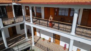 a woman walking on the balcony of a building at Tupac Huaraz in Huaraz