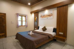 a bedroom with a large bed in a room at Hrishivan Resort Nagaon in Nagaon