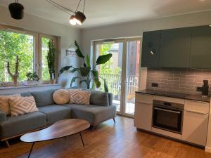 a living room with a couch and a kitchen at River View Old Town in Gdańsk