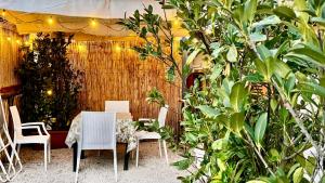 a table and chairs in a garden with plants at The Dream in Massa Lubrense