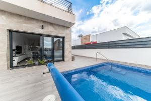a swimming pool in the backyard of a house at Villa Armonia - Heated Pool - Countryside Charm - by OYOOSTAYS in Daya Nueva
